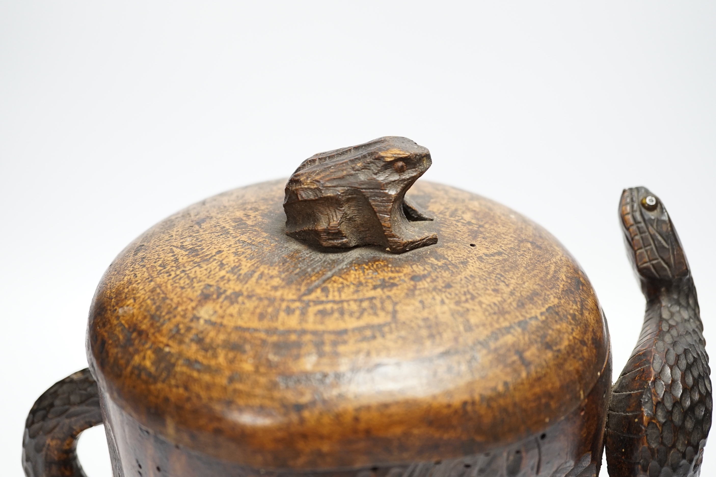 A Japanese carved wood tobacco jar in the form of a skull and snake, Meiji period, 21cm high